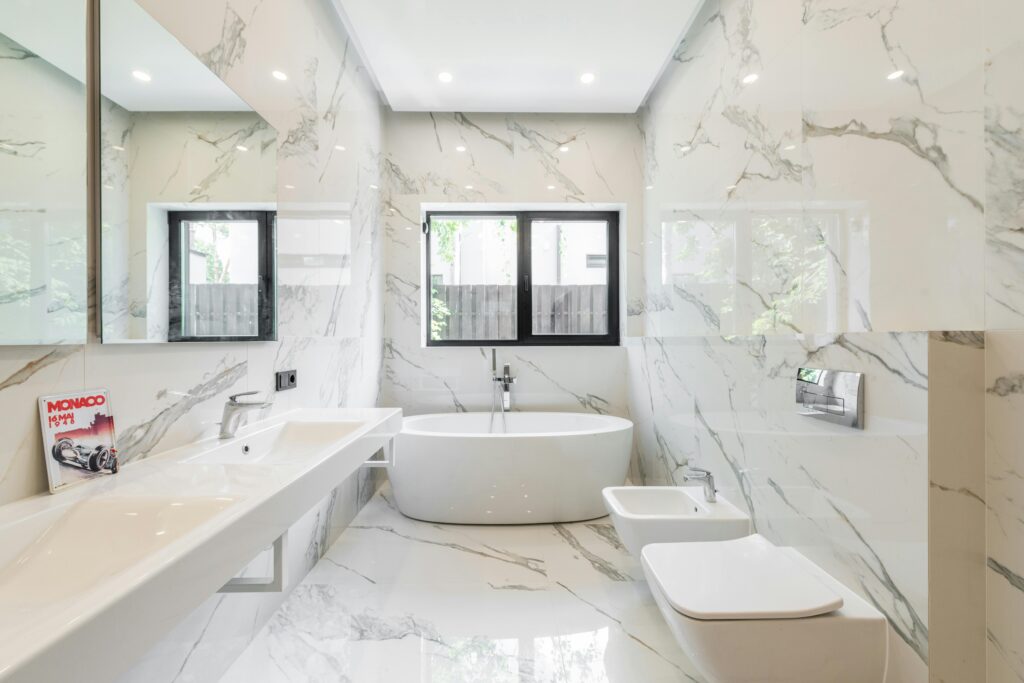 Elegant bathroom with marble tiles, bathtub, and modern fixtures for a luxury feel.